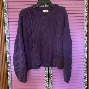 A purple sweater.